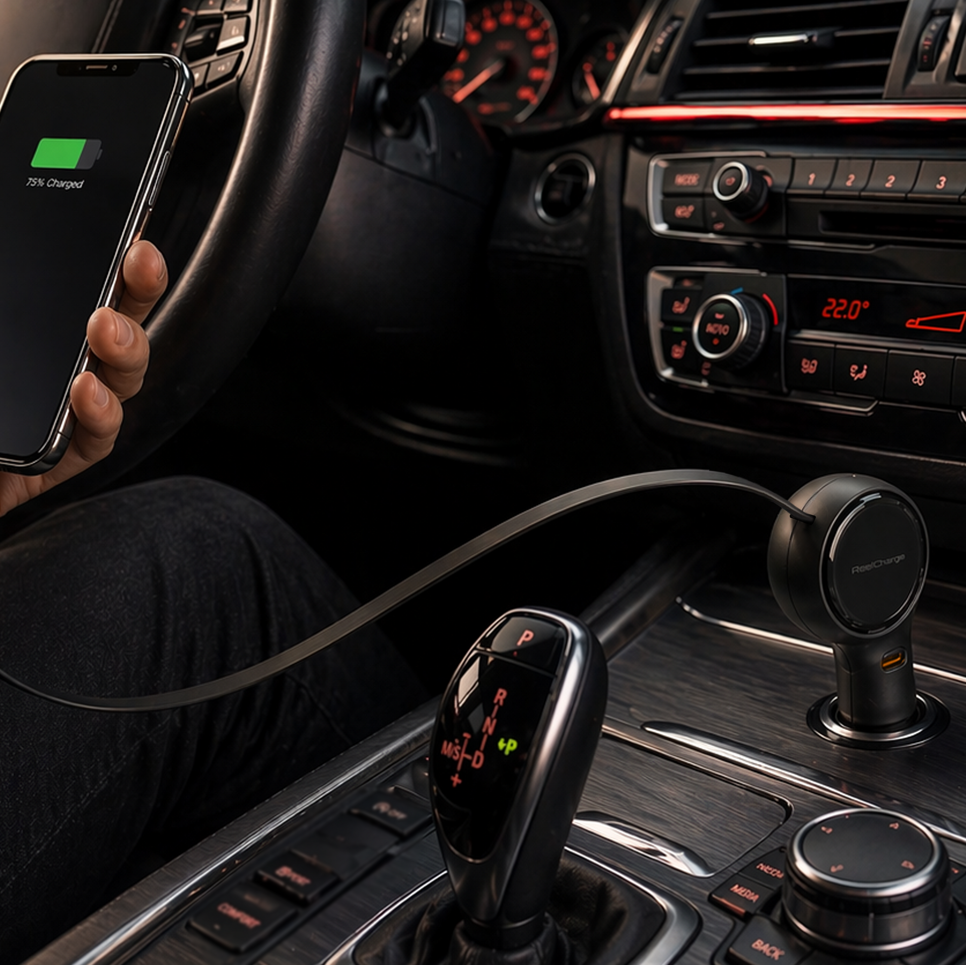 Black ReelCharge 60W car charger plugged into a car's 12V socket while a driver holds a charging phone