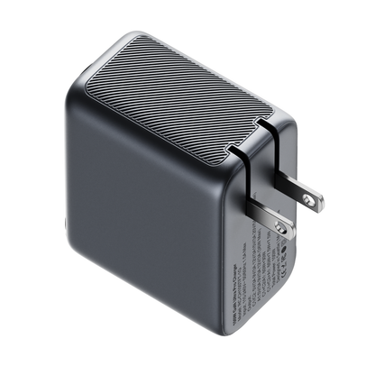 Top view of the ReelCharge 3-in-1 100W charger showing the ribbed housing and folding prongs