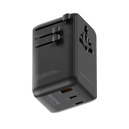 Angled view of the black ReelCharge 100W international travel adapter showing the universal socket