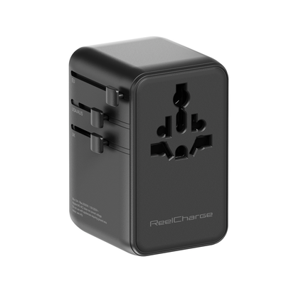 Rear angle of the black ReelCharge 70W global travel adapter showing the sliding prongs