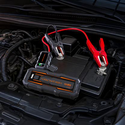 Veratek V8 Pro jump starter clamped to a car battery in an engine bay
