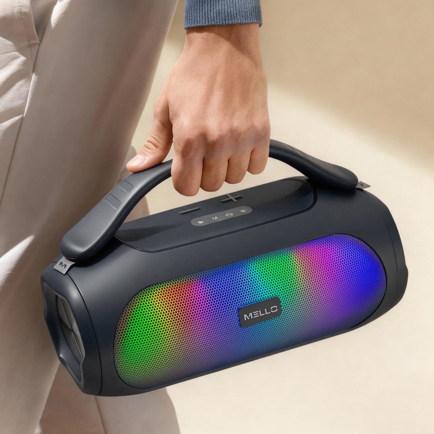 Hand carrying the Mello Flow 1000W Bluetooth speaker by its built-in handle