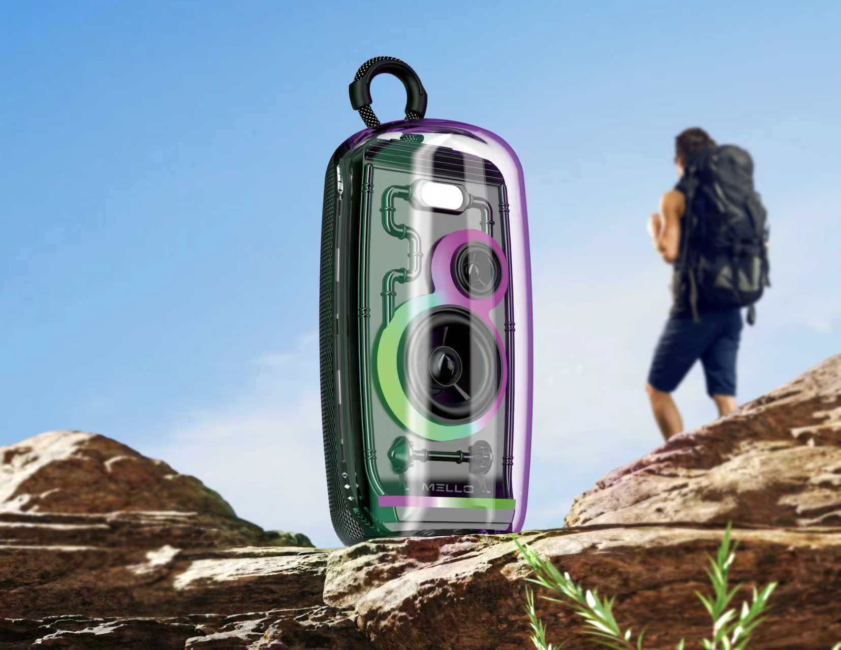 Mello Glitz transparent speaker with RGB lights on a rock while a hiker climbs behind