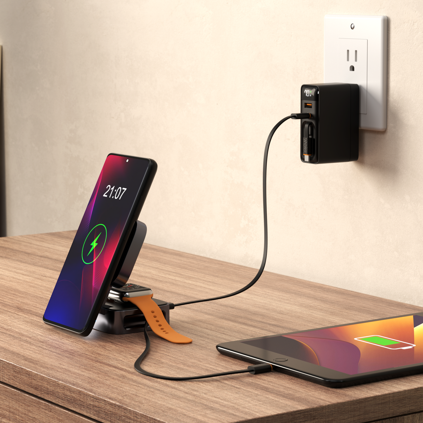 ReelCharge 5-in-1 power station on a desk charging a phone on the stand, a watch, and a tablet