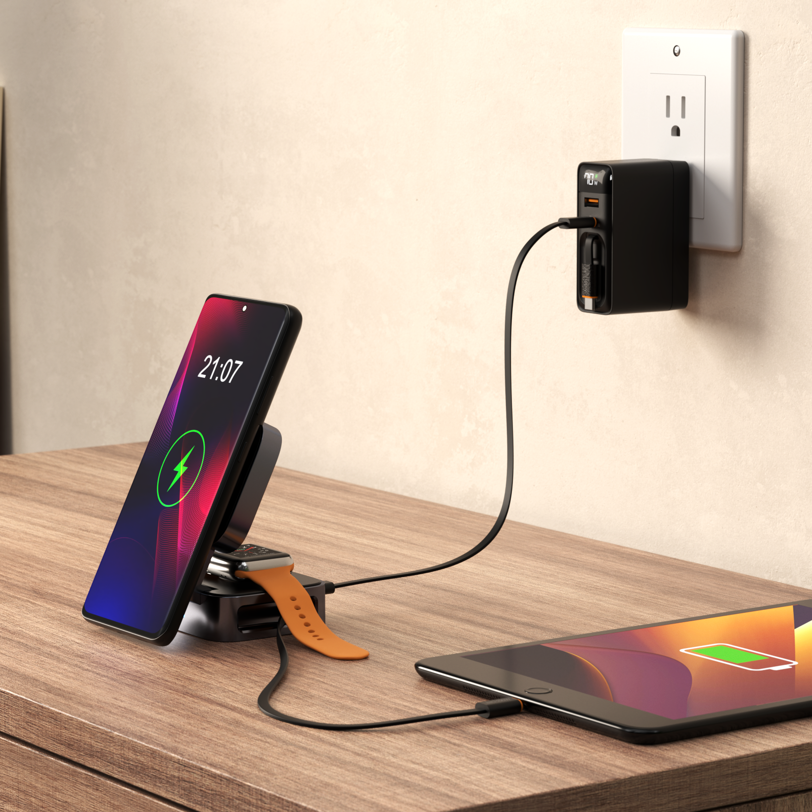 ReelCharge 5-in-1 power station on a desk charging a phone on the stand, a watch, and a tablet