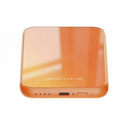 Angled view of the orange ReelSafe power bank showing the USB-C port and power button on the edge