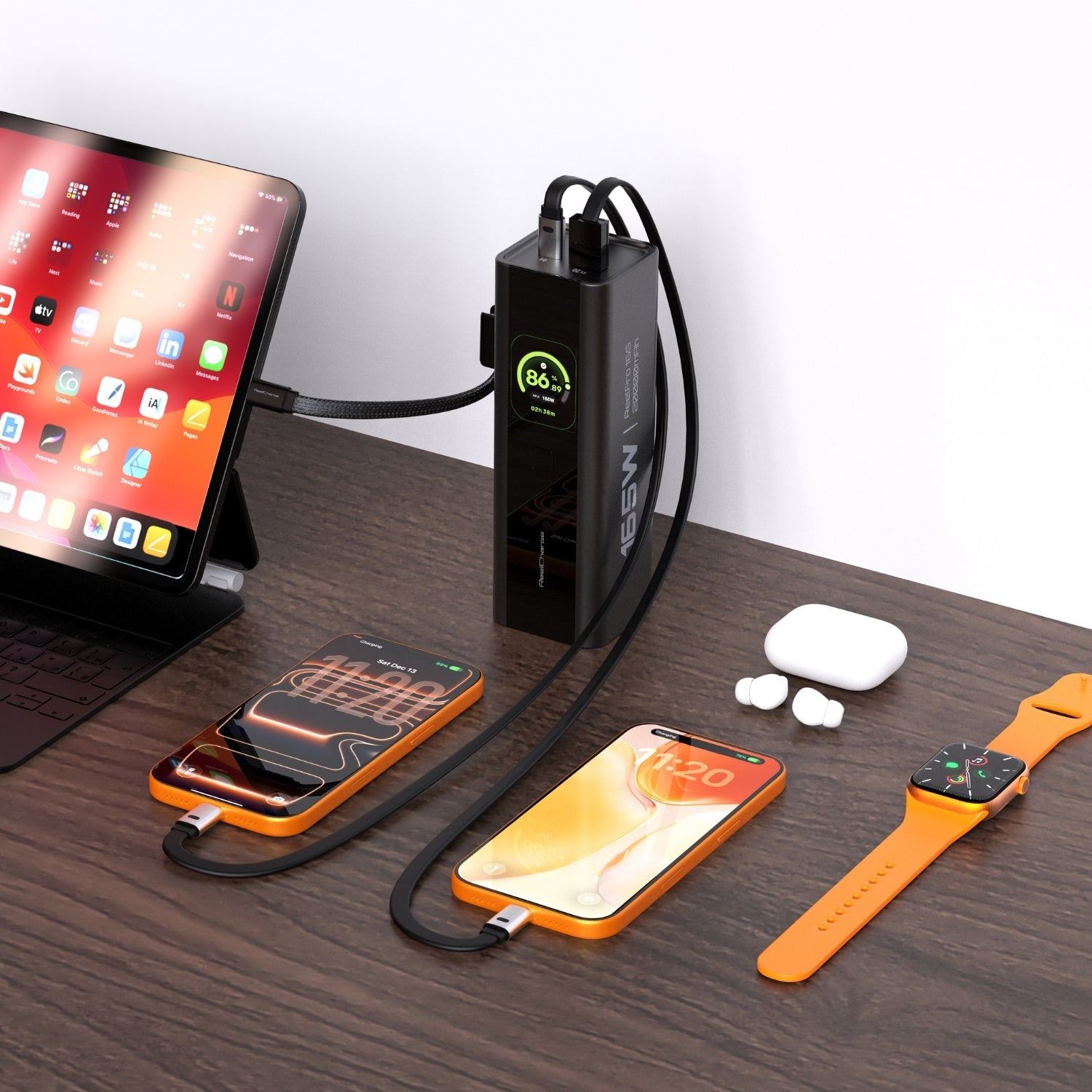 ReelPro 165W power bank on a desk charging an iPad, two phones, earbuds and a smartwatch at once