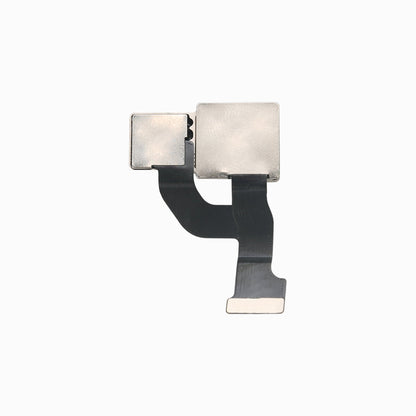 Back of iPhone 12 rear camera module showing metal shielding and flex ribbon connector
