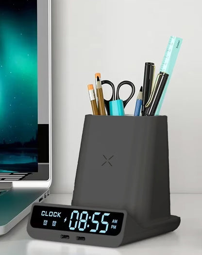 POM Desk Charge Pro on a desk next to a laptop, filled with pens, scissors and a ruler