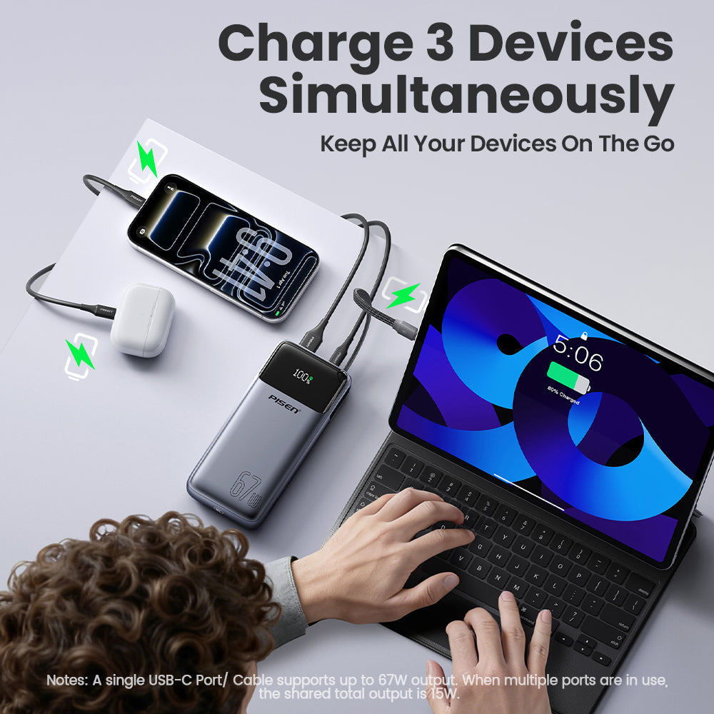 PISEN Bolt 67W power bank charging a phone, earbuds and iPad simultaneously on a desk