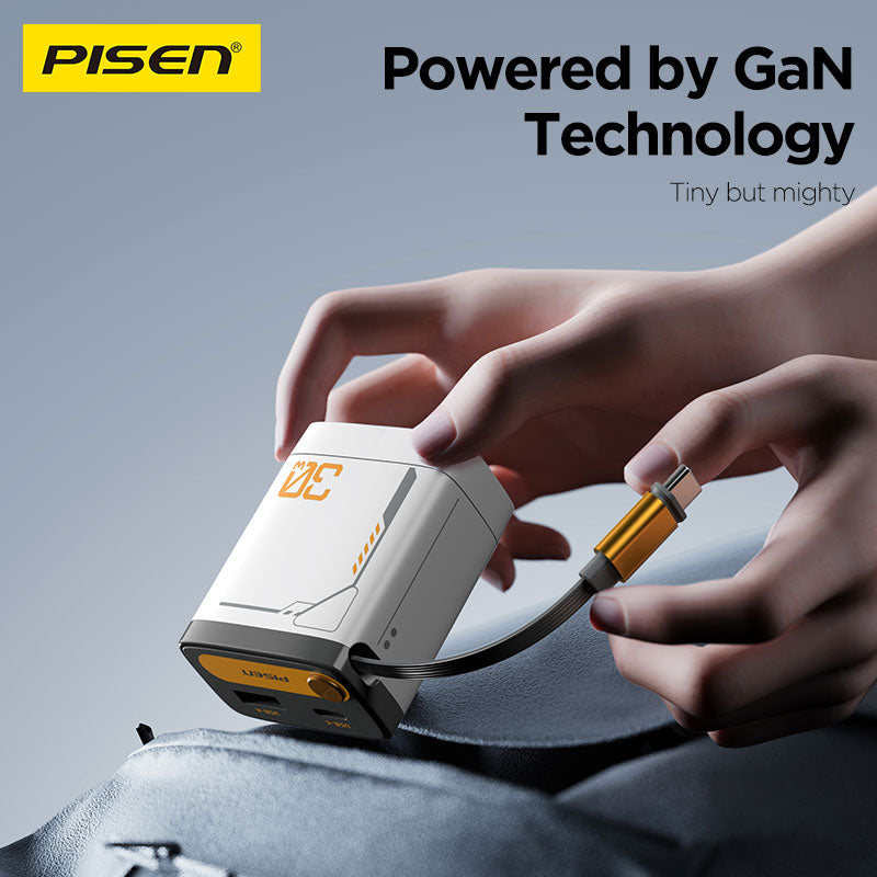 Hands holding the compact PISEN TP-C82 30W GaN charger, pulling out its retractable USB-C cable